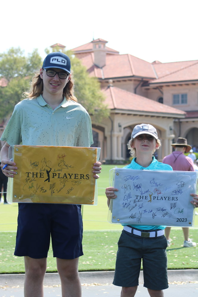Alex and Jonny Sprowles show off their autographed flags.